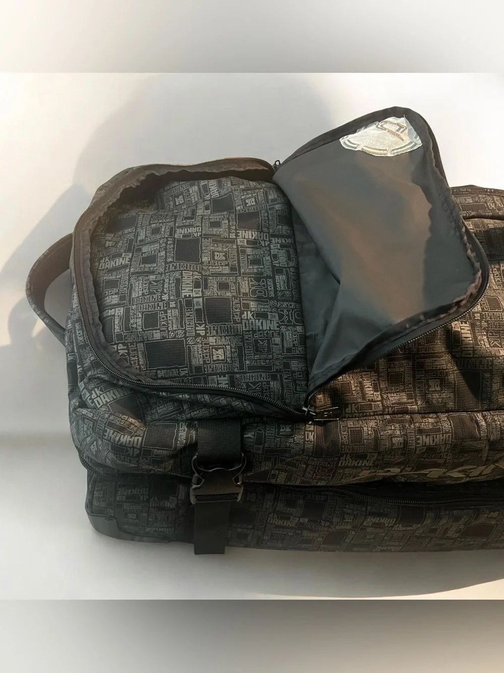 Dakine Split Roller 110L Wet Dry Duffel with a distinctive geometric pattern.